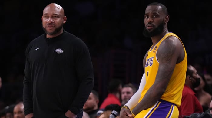 Lakers coach Darvin Ham (left) and forward LeBron James (6) sit and watch the action during a game against the Clippers.